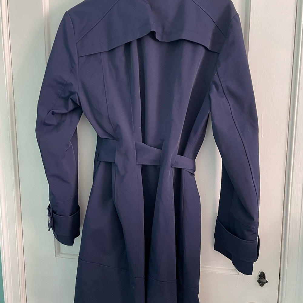 Double breasted raincoat. Color is navy. It is lined.